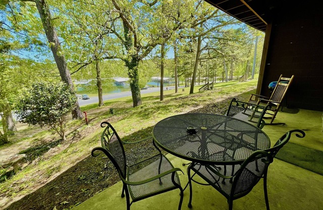 King Studio with king bed, dining area, sleeper sofa and view of Lake Ouachita by RedAwning