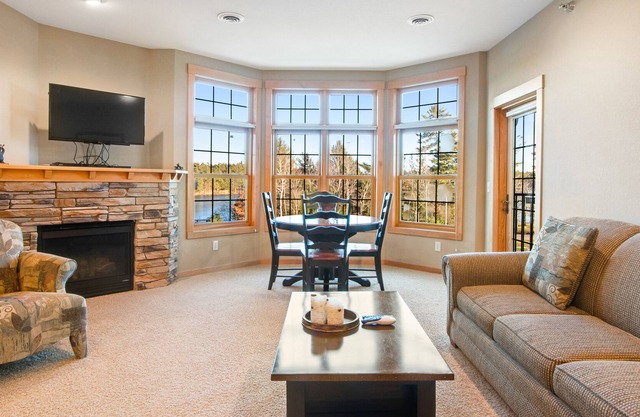Lake-view condo with balcony, gas fireplace, indoor pool, hot tubs, & gym