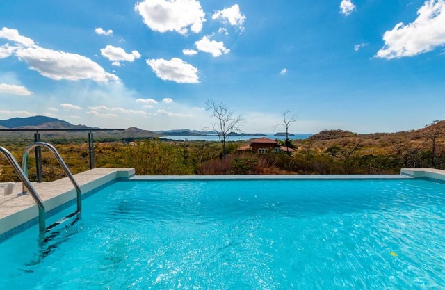 Modern Hillside Home with Sleek Interiors and Panoramic Poolside Views
