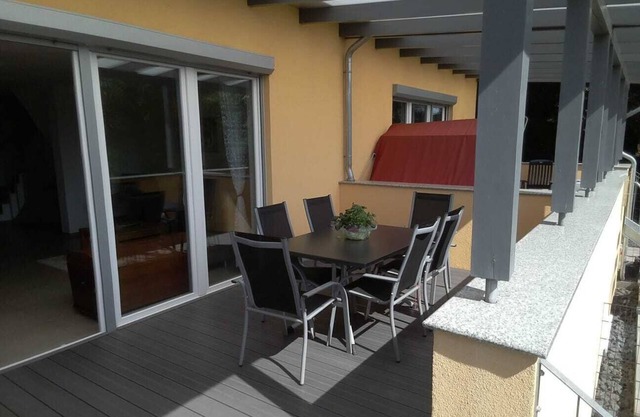 Modern semi-detached house with covered terrace and fenced garden.