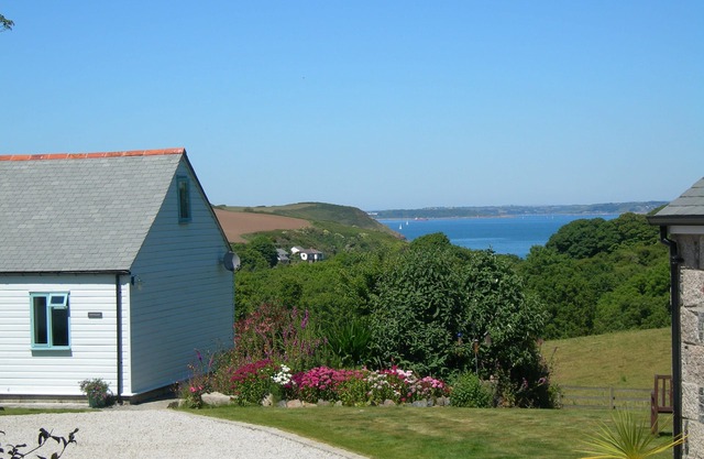 Quirky luxury chalet-style cottage, beautiful sea views across a wooded valley