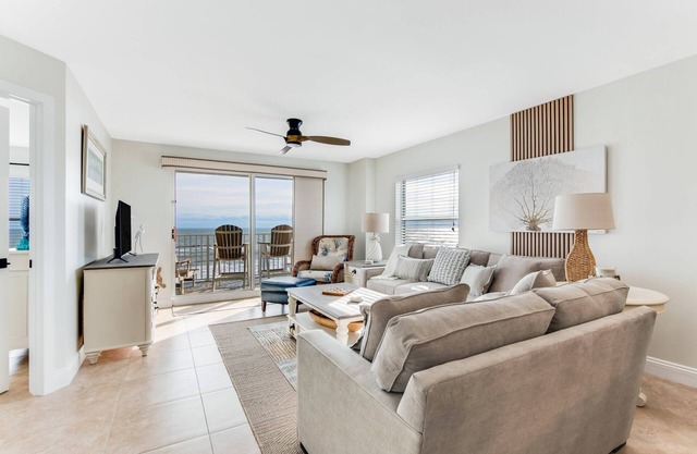 Renovated direct oceanfront corner condo with a large balcony, heated pool, and garage