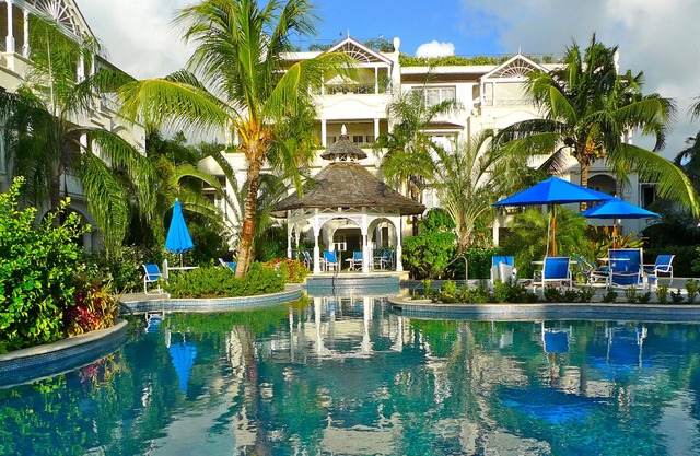 Schooner bay is a beachfront condominium with a freeform swimming pool as the focal point