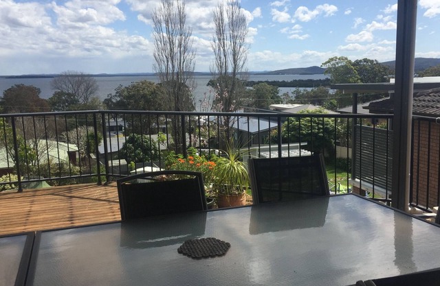 Spacious covered balcony overlooking Sunset beach. Large garden and water views