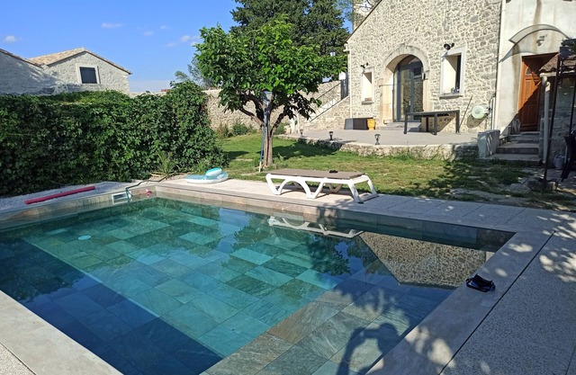 Stone house renovated in a contemporary style with garden and swimming pool.