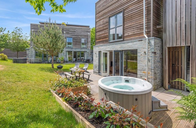 Stylish and contemporary pet friendly property featuring a wood-burning stove, patio hot tub and lar