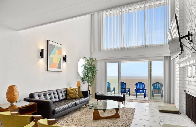 Three-level beachfront retreat with private rooftop deck, hot tub, & wet bar