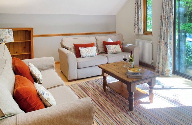 Timber lodge set in an elevated position with views of the lake.