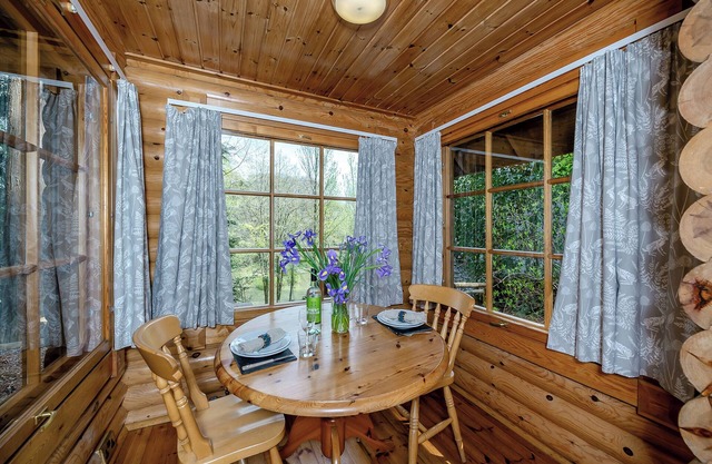Timber lodge set in an elevated position with views of the lake.