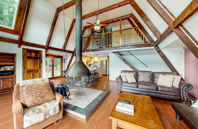 Waterfront home with wraparound deck, floating fireplace, deck, & firepit