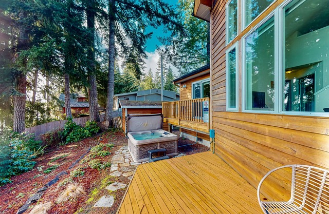 Waterfront home on Trails End Lake with private hot tub, fishing pier, & firepit