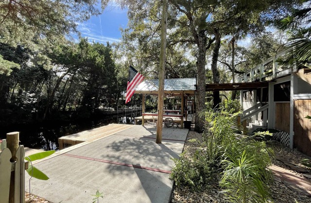 Waterfront Retreat with fenced yard, porch + bar, canal views, NEW DOCK