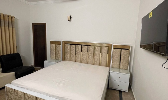 F-8 Sector House | 9 Bed Rooms House Featuring stunning mountain view with lush green lawn.