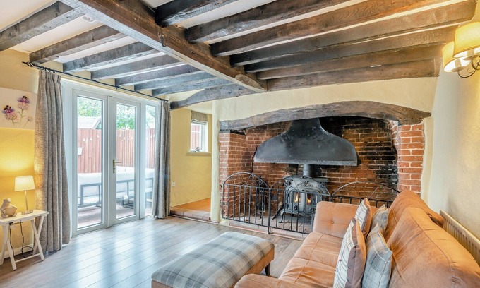 Saxthorpe Cottage | A spacious, bright property with a large inglenook fireplace and lovely furnishings.
