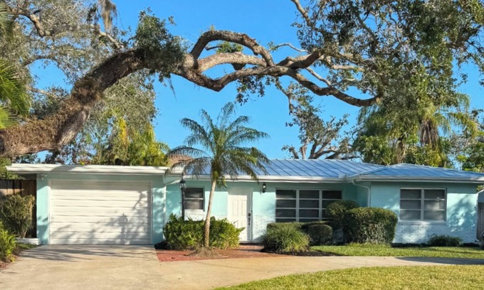 Central Beach House | A tropical retro bungalow secluded area with terrazzo flooring & heated pool.