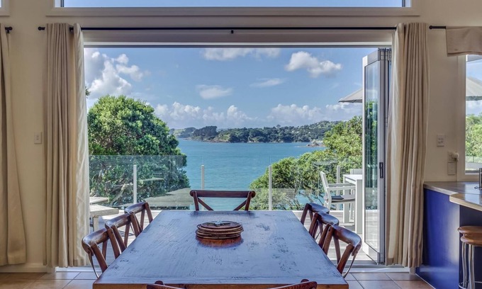 Oneroa House | Absolute Beachfront - Oneroa Bay - Enjoy gazing over Oneroa Beach from this impressive 2-story, 3-bedroom holiday house with a Spanish-inspired theme. Accommodating 8 guests who will all enjoy sitting directly beach front. Providing luxurious accommo
