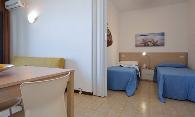 Lignano Sabbiadoro Apartment | Beautiful apartment for 4 people with pool, A/C, TV, terrace, pets allowed and parking