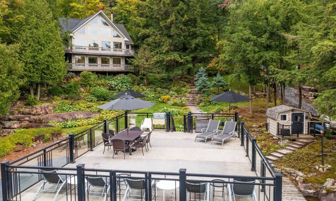 Muskoka Lakes Cottage | Beautifully landscaped with a sandy beach, outdoor sauna, hot-tub and ample water toys.
