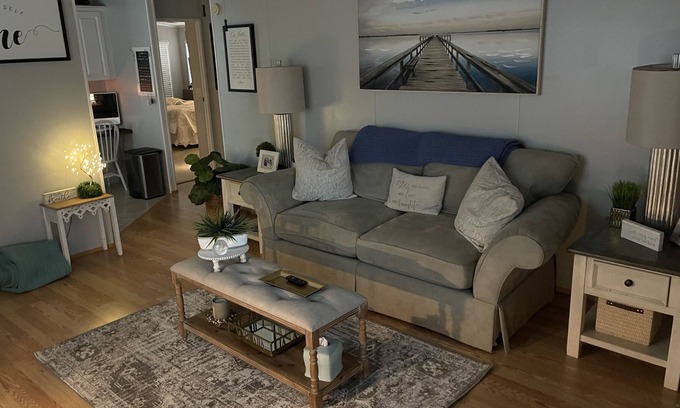 Charlotte Park House | Bedroom with a queen size bed and bath. Shared kitchen and lanai.