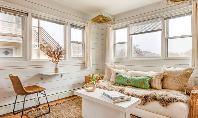 Montauk House | Bohemian-style hotel unit with ample natural light, a cozy seating area,.