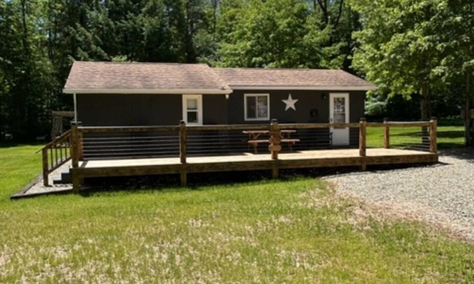 Tylersburg House | Camp Bear Bottom is a lovingly kept 1950s cabin where families gather to unplug and reconnect. Step inside to find an inviting indoor fireplace, fast Wi-Fi, and a fully equipped kitchen ready for your favorite recipes.