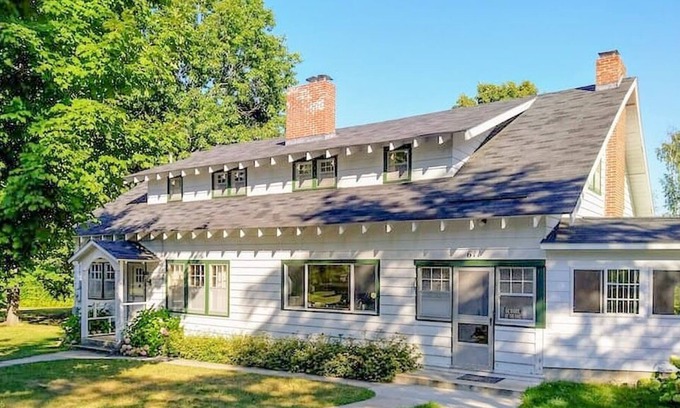 Lake Leelanau Cottage | Classic 1920 cottage on huge lot with boat dock, fire pit patio, beautiful views