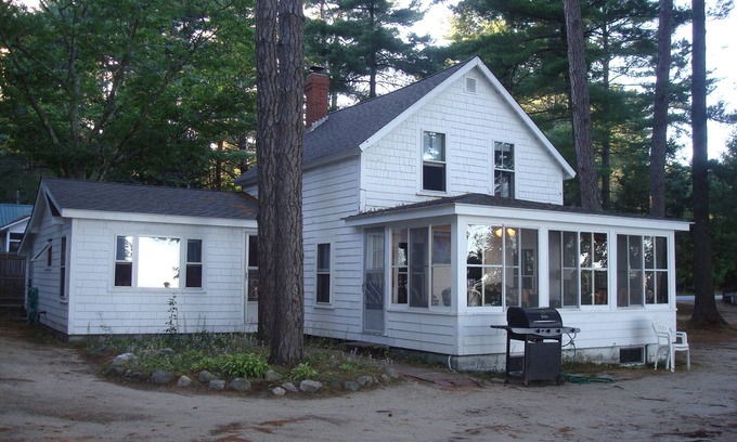North Sebago Cottage | Classic pine paneled Maine cottage with large sandy beach on Sebago Lake.