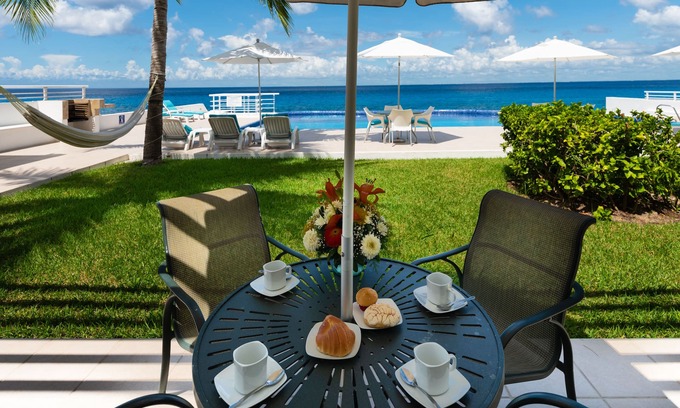 Zona Hotelera Norte Condo | Condo 101, Swimming pool level oceanfront condo, Pristine grounds and pool!