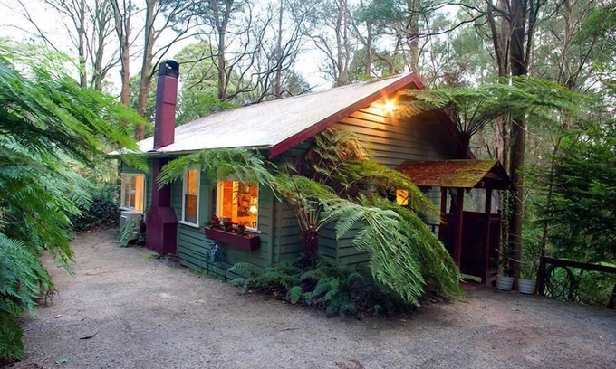 Olinda Cottage | Cottage In The Forest - Relax in your King size bed looking out onto the forest, curl up on the lounge with open wood fire.