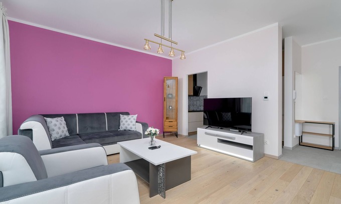 Stare Miasto District Apartment | Dark Grey and Pink Apartment by Renters