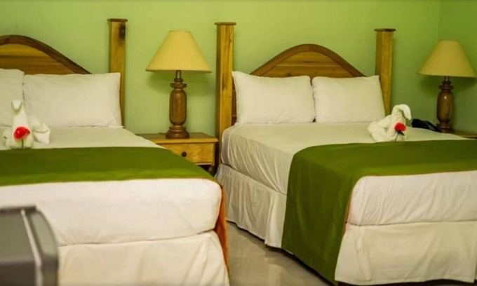 Runaway Bay Resort | Deluxe Quadruple Room, 2 Queen Beds, Garden View