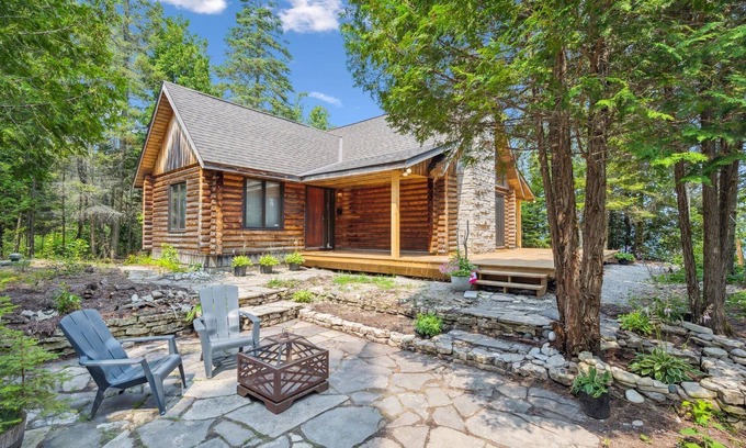 Lion's Head Cabin | Disconnect from it all at Stonewood, a cozy log chalet nestled in cedar forest on Georgian Bay. Enjoy a private shoreline, wraparound deck, wood stove, and access to kayaks, and trails. Peace, comfort, and adventure await in Cape Chin South.