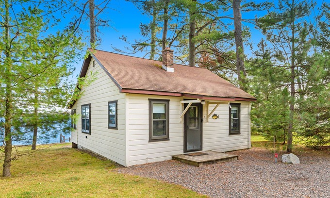 Presque Isle Cabin | Dog-friendly cabin with lakefront views, swimming, fishing, firepit, & rec room