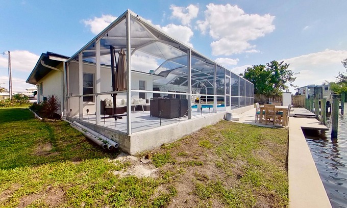 Fort Myers House | Dog-friendly home with private pool, dock, fireplace, patio, grill, & canal view