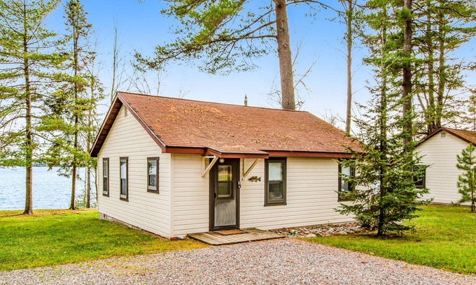 Presque Isle Cabin | Dog-friendly lakefront cabin with swimming, fishing, boating, & rec room