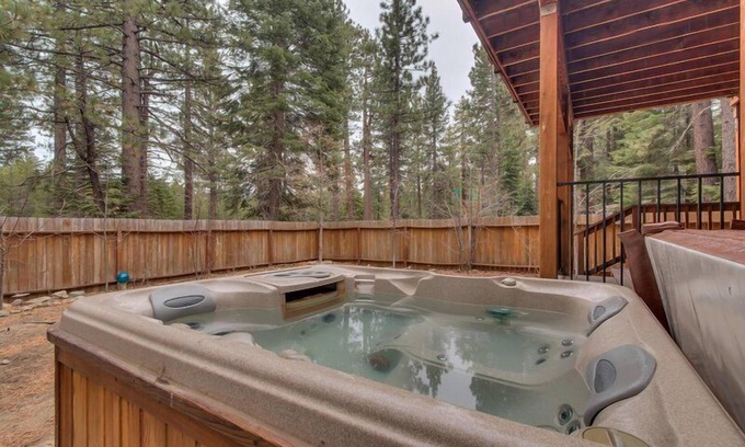 Tahoe Island House | Enjoy the tree-lined yard, spacious deck, and hot tub!