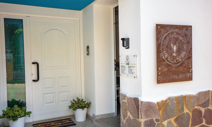 Cala Gonone Bed & Breakfast | Family room with mountain view terrace and window overlooking the harbor.