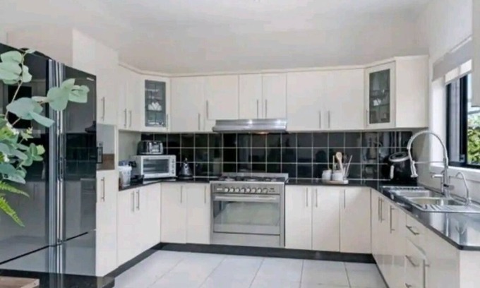 Merrylands House | Family room with shared facilities kitchen, laundry, bathroom and living area.