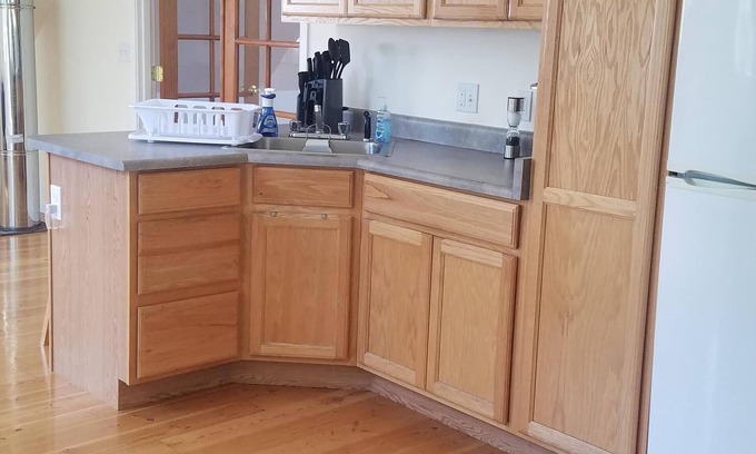 Sandpoint House | Full Suite w/ kitchen, private bedroom, sofa couches and large living area.