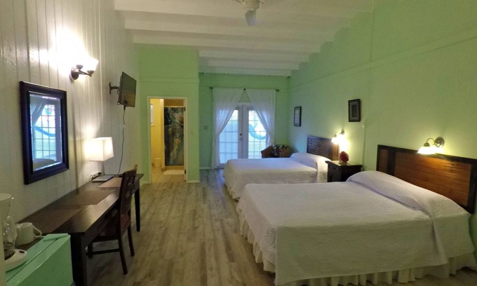 Cockburn Town House | Grand Turk Vibes B&B - Balcony room, with 2 queen beds with partial ocean view!