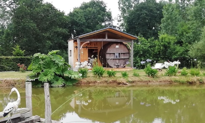 Baguer-Pican Cabin | INSOLITE A barrel in a green setting