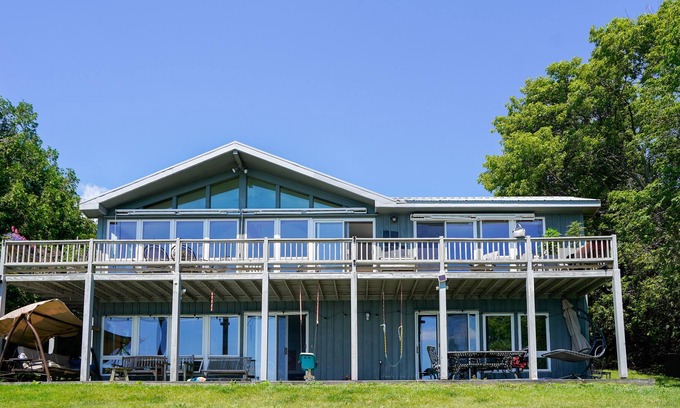 Schuyler Falls House | Lakefront home with fireplace, deck, patio, kayaks, and small beach