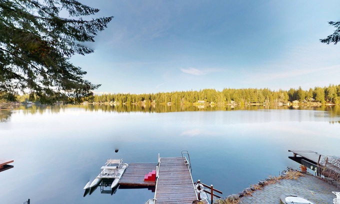 Mason County House | Lakefront studio-like home with beach access, lake views, wood stove, & firepit