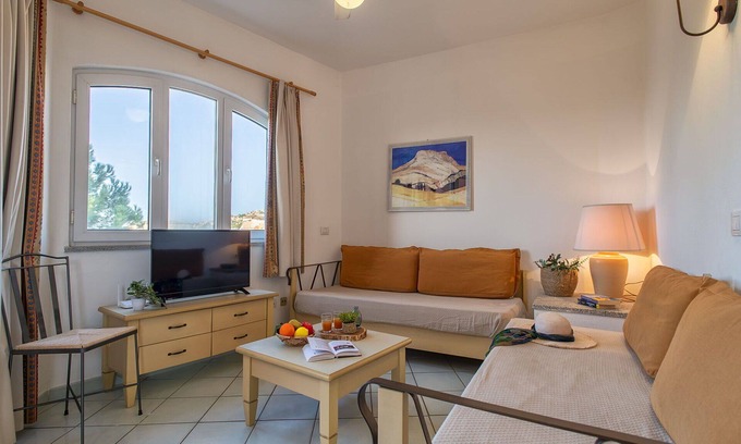 Canneddi Apartment | Lovely apartment for 4 people with pool, A/C, WIFI, TV, terrace, pets allowed and parking