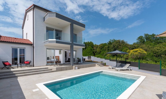 Peruski House | Modern vacation home with pool and sea view.