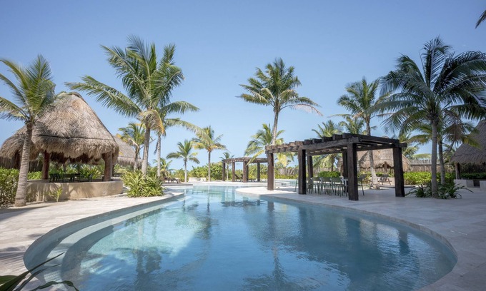 Ixil Apartment | Oceanfront retreat with private balcony, outdoor pool, and stunning views
