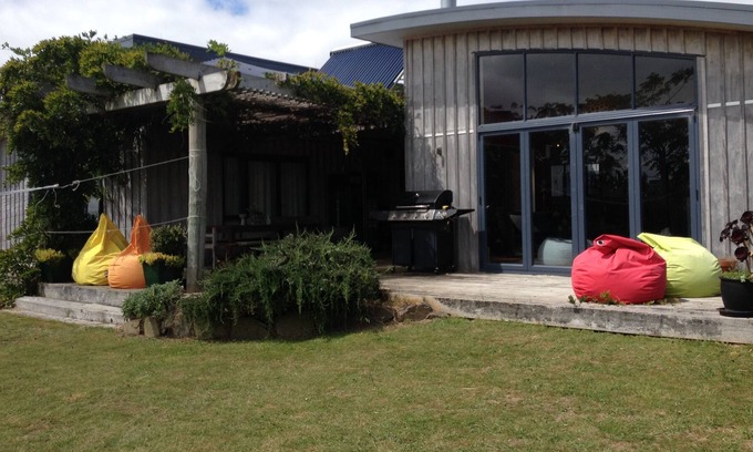 Raglan House | Okete Landing - Lifestyle retreat on Raglan harbour with grass tennis court.
