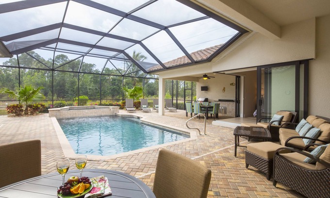 Central Naples House | overlooking a nature preserve and lake, this pool with spa home has it all