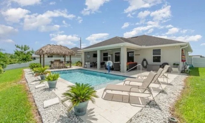 Trafalgar House | Paradise of Cape Coral on Canal, with Heated Pool, Tiki Hut Grill & Elec Bikes