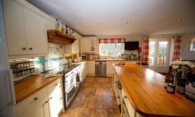 Trevone House | Polcarrek contemporary holiday home with parking and garden. Balcony with rural views